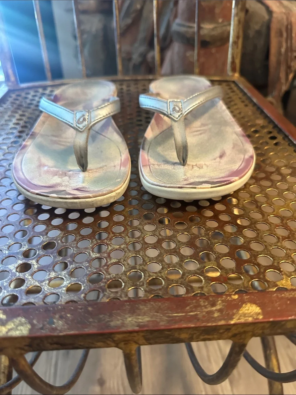OluKai Metallic Silver Flip Flops with Purple Floral Accent